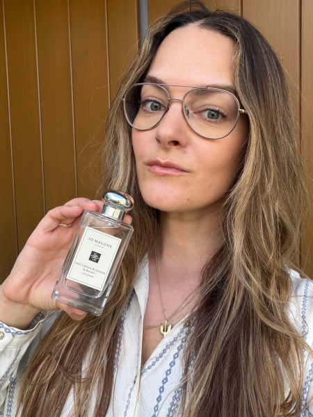 A selfie of Allure content director Sophia Panych holding the Jo Malone London Nectarine Blossom Honey Cologne